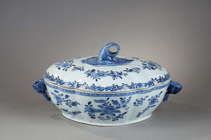 Tureen and its cover in blue white porcelain from a European orfevrerie model - flowers shaped handles